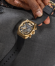 GW0638G1 GUESS Mens Black Gold Multi-function Watch lifestyle hand holding watch