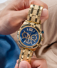 GUESS Mens Gold Tone Multi-function Watch lifestyle hand holding watch