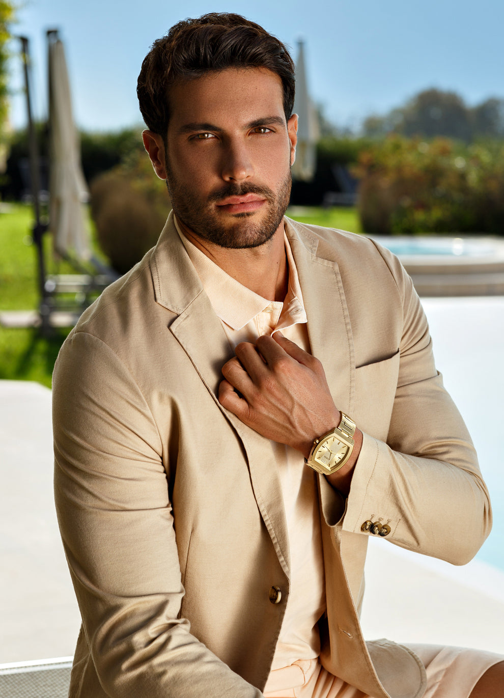 man in brown jacket wearing gold watch