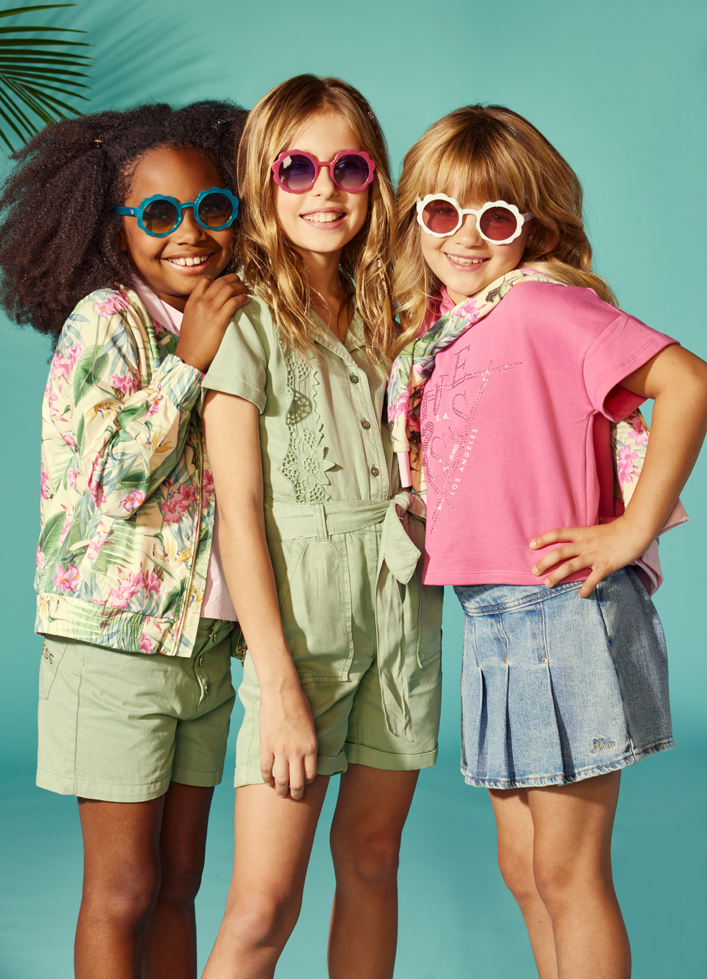 three girls standing wearing sunglasses