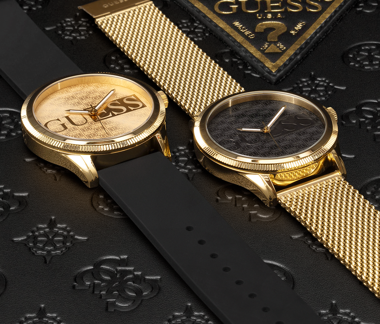 black and gold mens watches lying down with logos on dial