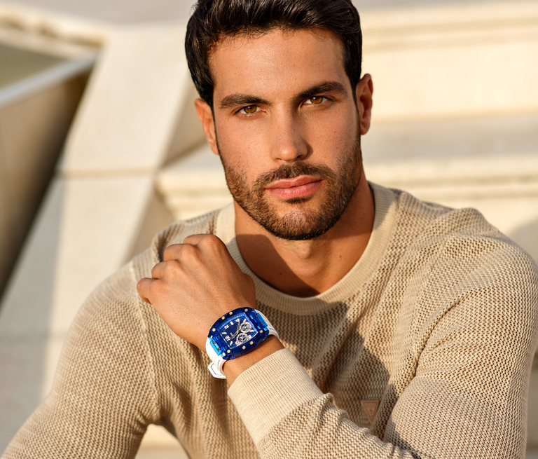 man wearing blue and white guess watch