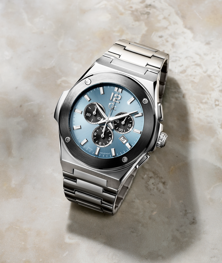 mens silver watch with blue dial on marble background
