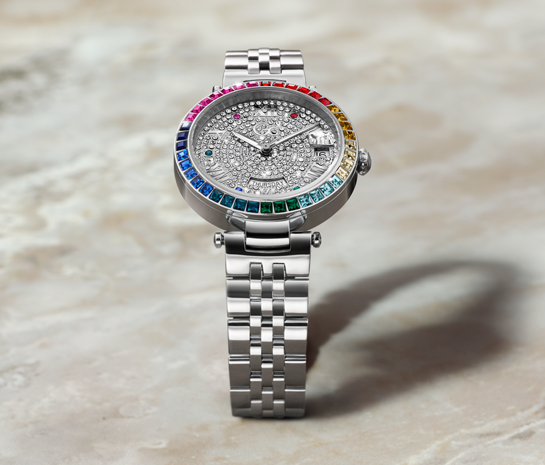 silver watch with colored gems on bezel