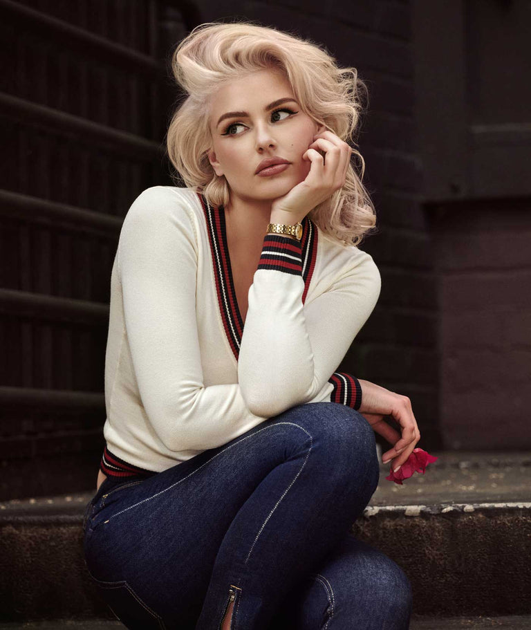 woman wearing white sweater and gold GUESS watch