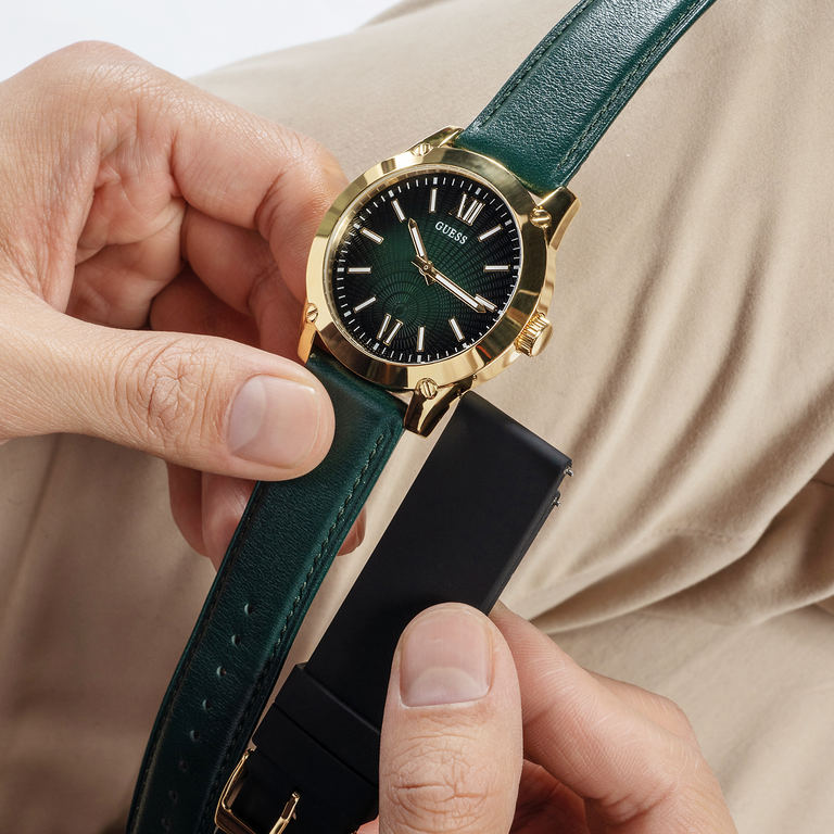 hand holding green and gold watch with matching black band