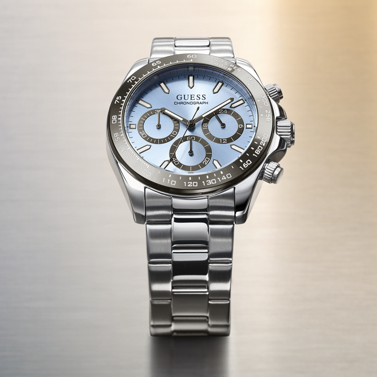 Silver Guess watch with a light blue face on a gradient background