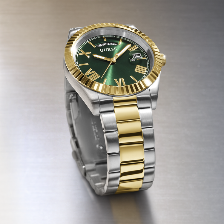 Two-tone silver and gold watch with green dial on a gradient background