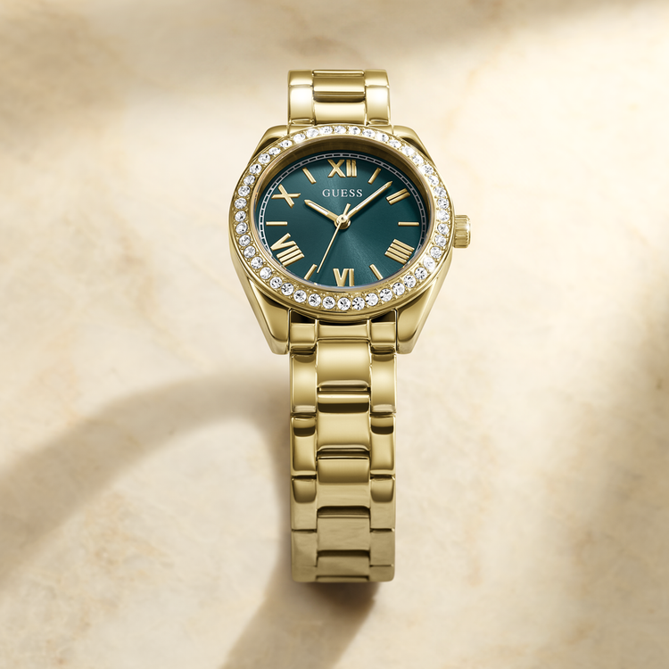 Gold watch with a green face on a beige background