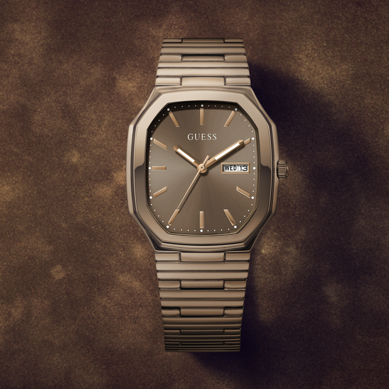 Guess watch with mocha metallic band on a brown textured background