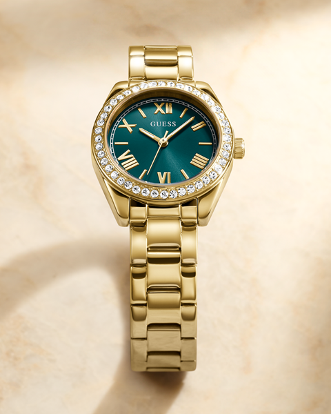 Gold watch with a green dial and gemstone accents on a beige background
