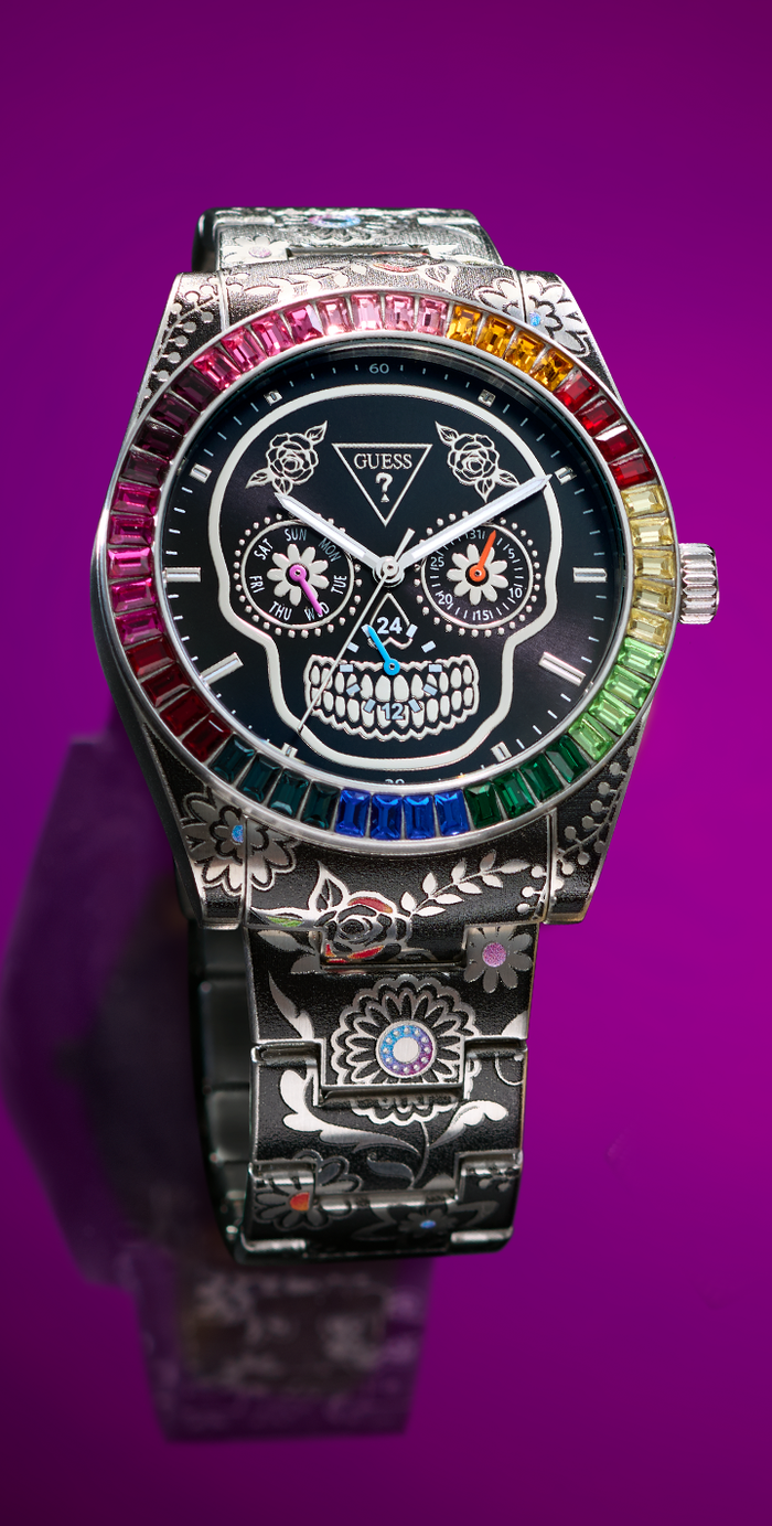 Wristwatch with skull design and rainbow-colored bezel on a purple background gw0962g1
