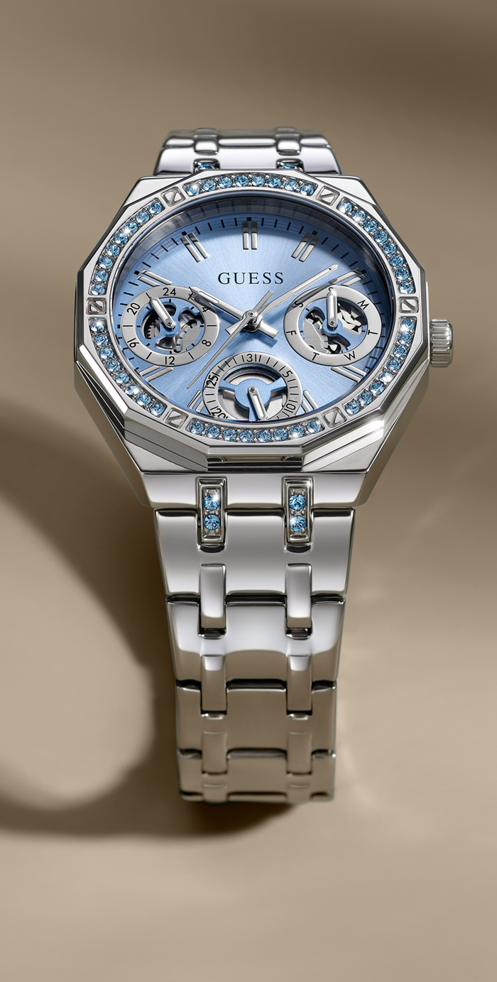 Silver watch with a blue face on a beige background 