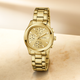 Gold watch with a detailed face on a beige background