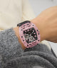 GUESS Mens Sporting Pink Multi-function Watch on a wrist with a blurred background