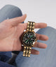 GW0220G2 GUESS Mens Gold Tone Day/Date Watch model holding watch