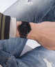 Person wearing a black watch on a white background