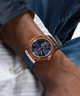 GW0491G4 rose gold watch on wrist with blue silicone strap lifestyle