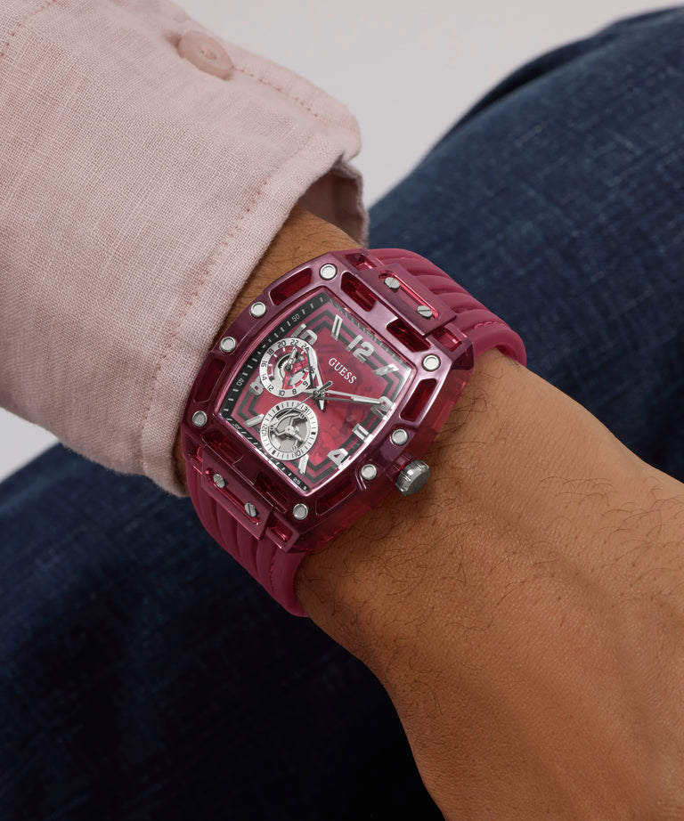 Close-up of a wrist wearing a red GUESS Mens Red Analog Watch with a detailed face.