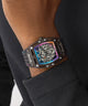 GUESS Mens Black Multifunction Watch with a unique design on a person's wrist against a dark background