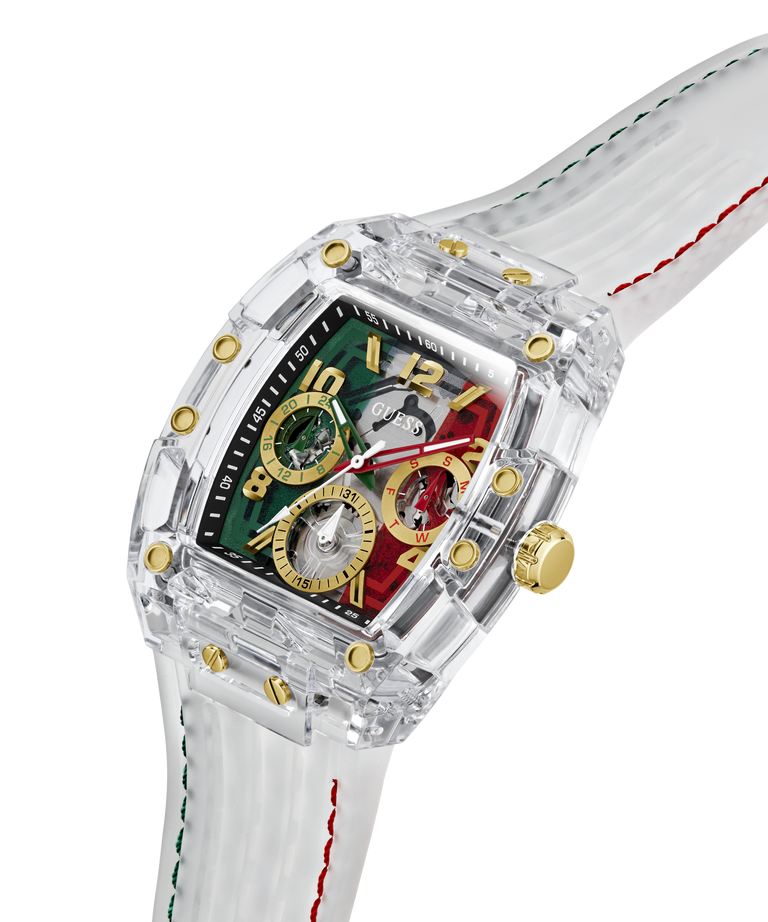 A luxury wristwatch with a transparent acrylic case, gold-tone case details, and a multi-colored dial featuring green, red, and gold sections. The watch has a white silicone strap with green and red stitching, shown on a clean white background. lifestyle
