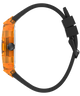 A side profile view of a smartwatch with a translucent orange case and a matte black strap, shown against a solid white background.