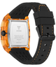Back view of a GUESS watch with a transparent orange case, black stainless steel back, and black rubber strap with orange stitching, on a white background.