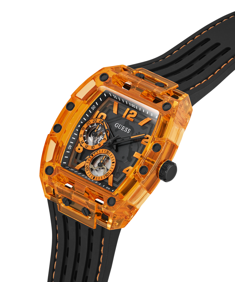 A GUESS wristwatch with a transparent orange case, black skeleton dial, and black rubber strap with orange stitching, shown on a white background. lifestyle