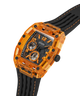 A GUESS wristwatch with a transparent orange case, black skeleton dial, and black rubber strap with orange stitching, shown on a white background. lifestyle
