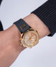 GW0617L5 GUESS Ladies Black Gold Tone Analog Watch watch on wrist