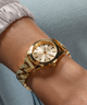 GUESS Ladies Gold Tone Analog Watch lifestyle gold chain watch on wrist