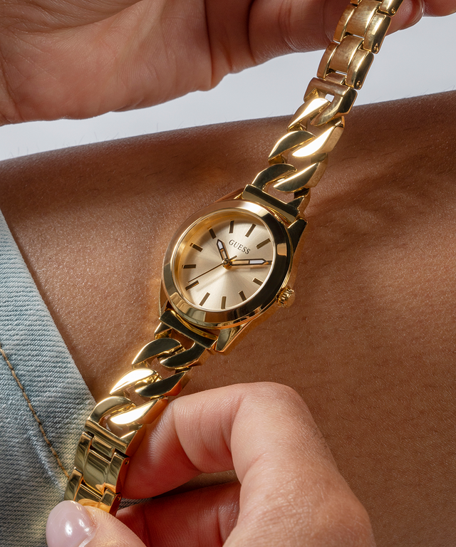 GUESS Ladies Gold Tone Analog Watch lifestyle hand holding gold watch