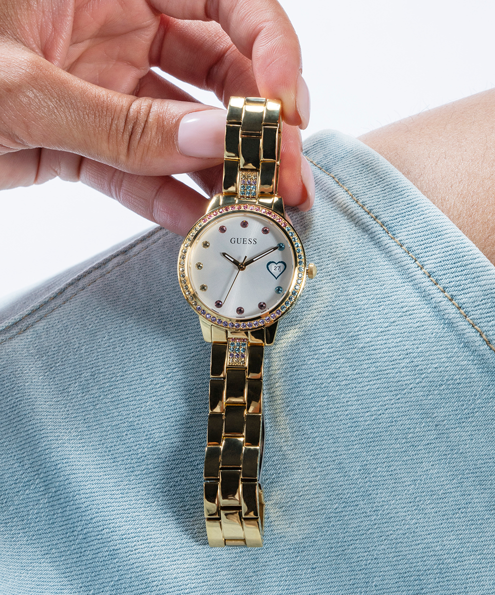 GUESS Ladies Gold Tone Date Watch lifestyle hand holding watch