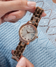 GUESS Ladies Rose Gold Tone Date Watch lifestyle hand holding watch