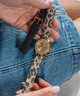 hand holding watch straps GUESS Ladies Gold Tone Multi-function Watch Box Set lifestyle
