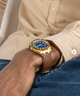 GUESS Mens Brown Gold Tone Analog Watch lifestyle gold and blue watch on wrist