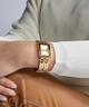 GUESS Ladies Gold Tone Analog Watch lifestyle watch on wrist white sweater