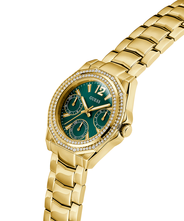 Gold watch with a green face on a white background lifestyle
