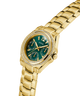 Gold watch with a green face on a white background lifestyle