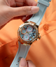 GUESS Ladies Blue Gold Tone Multi-function Watch lifestyle hand holding watch