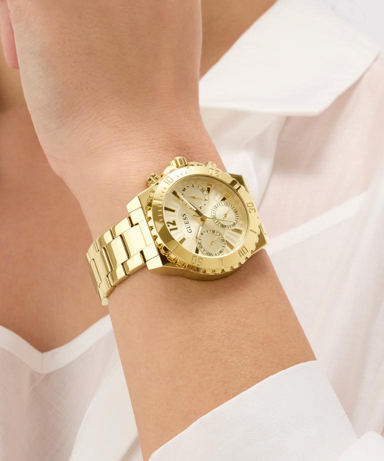 Gold watch on a wrist with a white shirt