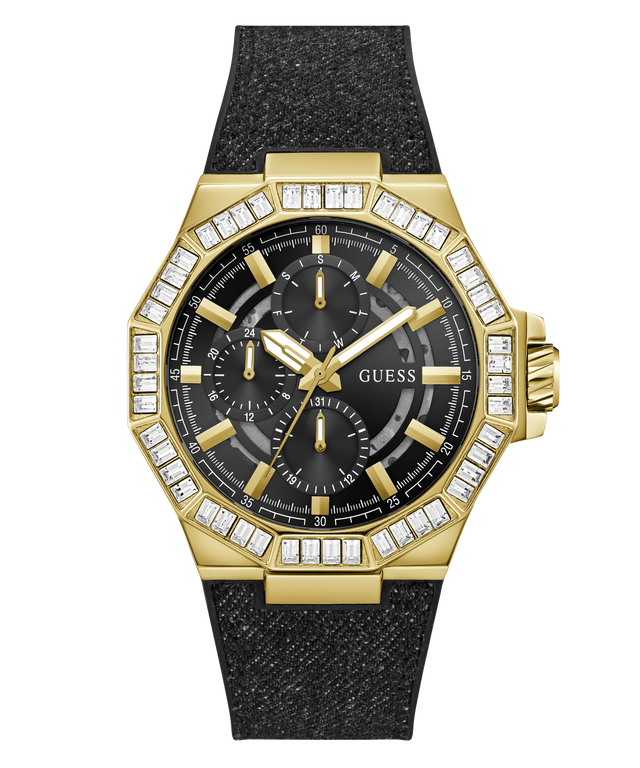 A gold-tone GUESS watch with an octagonal bezel set with clear stones, a black dial with three subdials, and a textured black strap, shown on a plain white background.