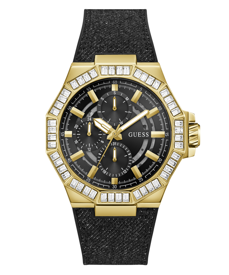 A gold-tone GUESS watch with an octagonal bezel set with clear stones, a black dial with three subdials, and a textured black strap, shown on a plain white background.