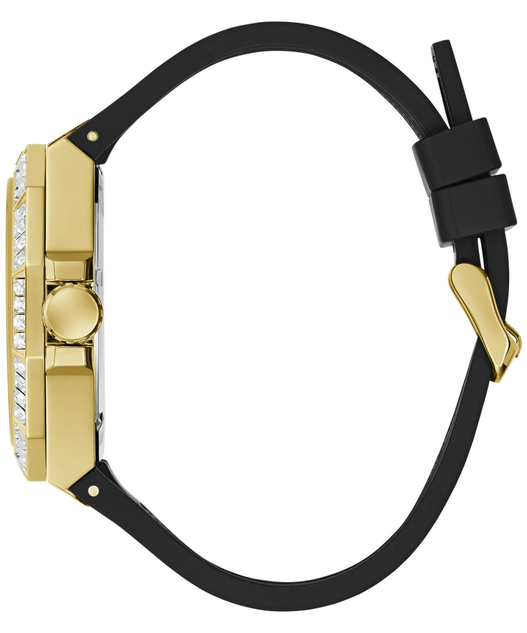 A close-up side view of a luxury watch featuring a polished gold-tone case, a bezel set with clear crystals, and a black rubber strap with a gold buckle.