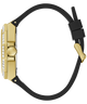 A close-up side view of a luxury watch featuring a polished gold-tone case, a bezel set with clear crystals, and a black rubber strap with a gold buckle.