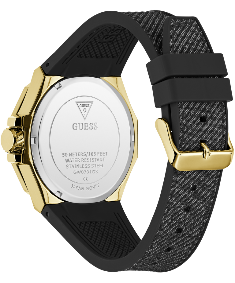 Back view of a Guess watch with a gold-tone stainless steel case and a textured black silicone strap, on a white background.