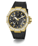 A gold-tone GUESS chronograph watch with a black textured strap, featuring a bezel set with clear crystals and a black dial with gold hands and subdials.