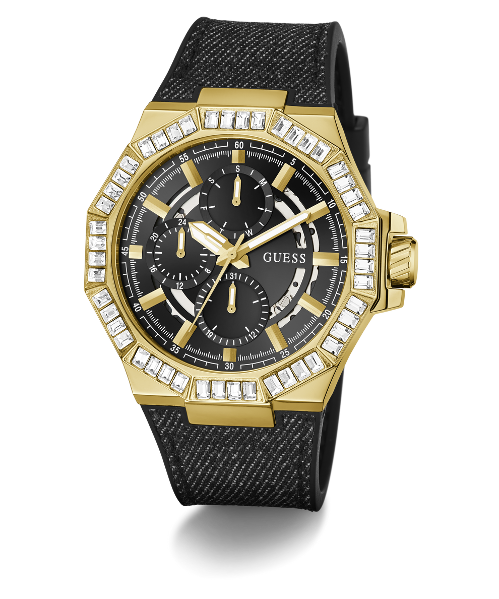 A gold-tone GUESS chronograph watch with a black textured strap, featuring a bezel set with clear crystals and a black dial with gold hands and subdials.