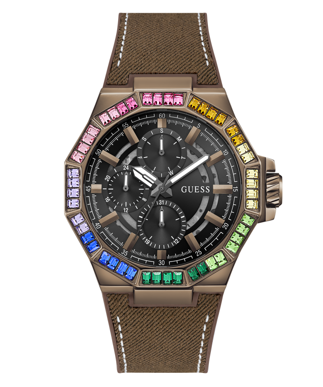 A GUESS wristwatch with a bronze-toned case, a black dial with three subdials, and a brown textured strap. The bezel is decorated with colorful rhinestones in blue, green, yellow, pink, and orange.