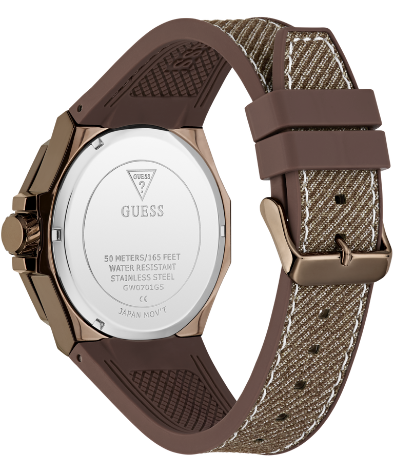 Rear view of a Guess watch with a brown textured silicone strap and a rose gold case, showing the stainless steel case back engraved with the Guess logo.